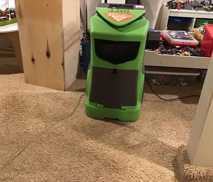 SERVPRO dehumidifier in work for the carper