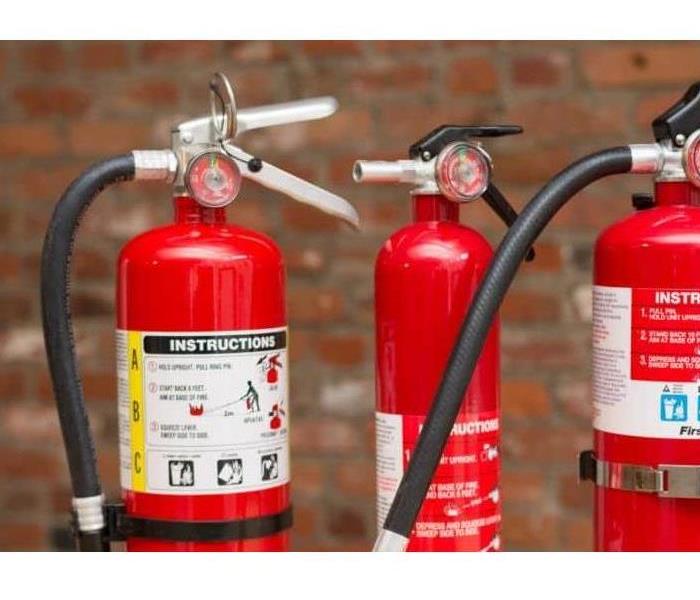three fire damage extinguishers